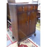 AN OAK MILLINERY CABINET WITH TWO SHORT DRAWERS OVER TWO DOORS