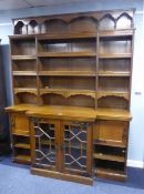 VICTORIAN OAK LIBRARY BOOKCASE, THE BREAKFRONT BASE WITH CORNICE LIP AND CENTRAL CUPBOARD ENCLOSED