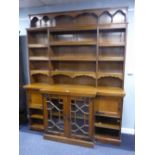 VICTORIAN OAK LIBRARY BOOKCASE, THE BREAKFRONT BASE WITH CORNICE LIP AND CENTRAL CUPBOARD ENCLOSED