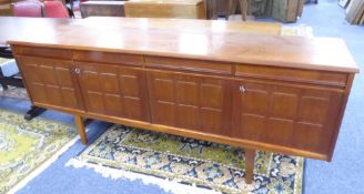 1970'S TEAK WOOD LONG, LOW SIDEBOARD WITH FOUR FRIEZE DRAWERS OVER FOUR EMBOSSED PANEL DOORS