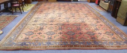 AN AXMINSTER DEEP WOOL PILE TURKEY PATTERN CARPET WITH DEEP ROSE GROUND FILLED WITH PATTERNED BLUE