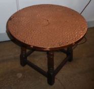 AN OAK COFFEE TABLE WITH BEATEN COPPER CIRCULAR TOP