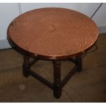 AN OAK COFFEE TABLE WITH BEATEN COPPER CIRCULAR TOP