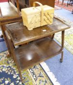 A LIGHT WOOD CANTILEVER SEWING BOX; A WOODEN TWO TIER TEA TROLLEY, 1970S STYLE AND A TEAK TWO TIER