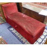 AN OTTOMAN COUCH WITH SINGLE SCROLL END, COVERED IN CRIMSON VELVET