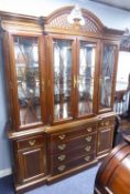 A MAHOGANY COLONIAL STYLE BREAKFRONT DISPLAY CABINET, WITH PIERCED BROKEN ARCH PEDIMENT, FOUR GLAZED
