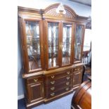 A MAHOGANY COLONIAL STYLE BREAKFRONT DISPLAY CABINET, WITH PIERCED BROKEN ARCH PEDIMENT, FOUR GLAZED