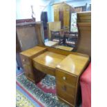 AN OAK DOUBLE PEDESTAL DRESSING TABLE WITH FRAMELESS MIRROR and a matching BEDSIDE CABINET