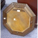 A MIRROR WITH BEVELLED EDGE OCTAGONAL PLATE, 14 ½", IN OAK CANTED FRAME WITH GREEK KEY MOTIF MOULD