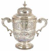 A substantial Victorian silver twin handled trophy cup, London 1892 the knopped finial, flower