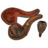 A Meerschaum pipe, early 20th century, carved in the form of a chicken's claw with silver band, in a