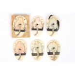 A collection of Art Nouveau ivory pendants with central Japanese figure of pierced form, hand