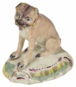A Derby Pug Dog, 19th century seated on hind legs with down turned mouth, body with a black