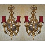 A pair of gilt wood Chippendale style twin branch wall sconces the wall mount with pierced ribbon