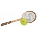 A Snauwaert oversized wooden tennis racket and tennis ball, possibly used for advertising purposes