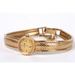 A ladies 9ct gold wind mechanism Omega bracelet watch, circa 1960 The small circular dial with baton