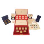 A cased set of seven silver gilt Coronation Issue replica stamps ingots, each with serrated edge and