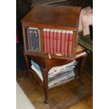 A mahogany revolving bookcase, mid 20th century the square top with four sections to hold books
