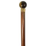 A Victorian tiger's eye walking stick the malacca shaft terminating in a tiger's eye spherical