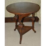 A mahogany circular side table, 19th century with three turned wrythen splayed supports united by