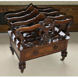 A Victorian mahogany Canterbury of typical form with three sections, each with pierced carved