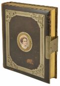 An interesting leather bound Victorian photograph album with vignette to the front with painted