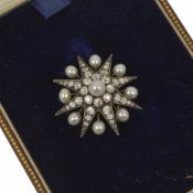 A good Victorian diamond and pearl brooch of star design, with central pearl and old cut diamond