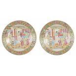 A pair of late 19th century Chinese famille rose plates each with central scene depicting