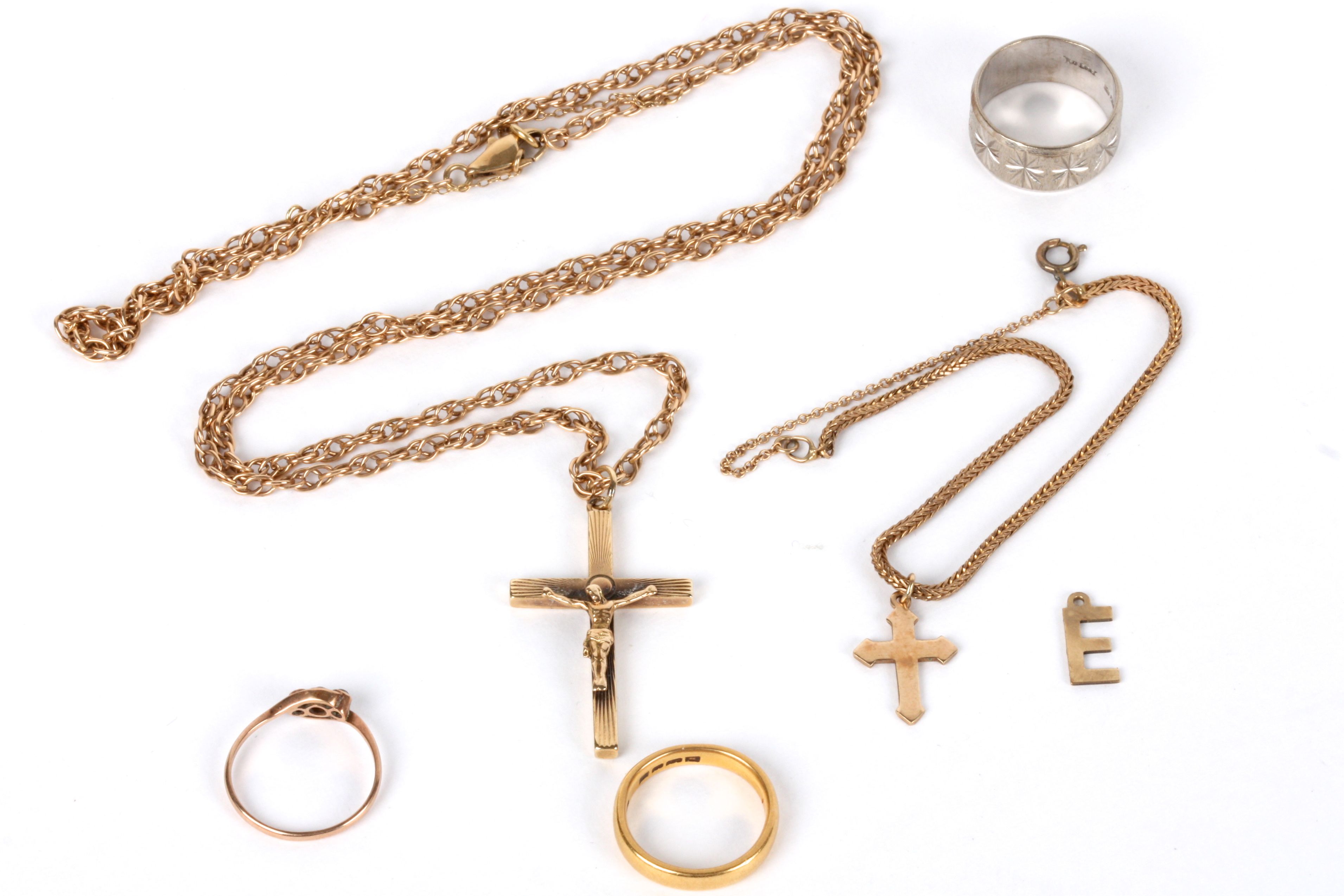 A collection of various gold jewellery to include a 22ct gold wedding band, a 9ct gold crucifix on