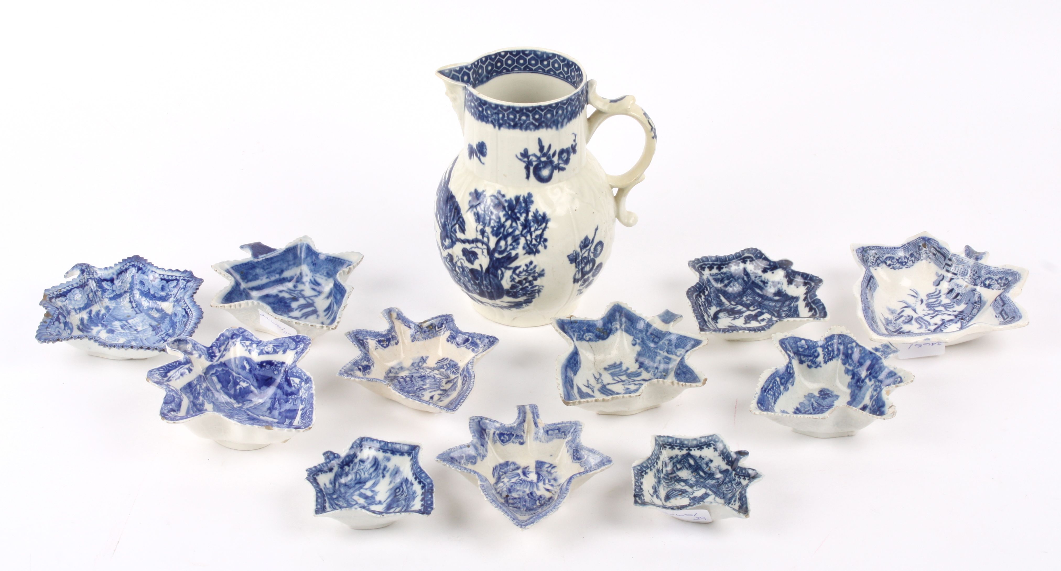 An 18th Century Worcester parrot and fruit pattern jug crescent mark to base together with an