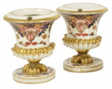 A pair of Derby porcelain Imari pot pourri urns, early 20th century of urn form with a central