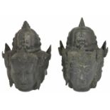 A pair of antique three sided bronze heads, possibly Tibetan the female heads with spiked helmets