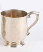 A Victorian silver tankard, London 1876, of simple form with scrolled handle, the body engraved with