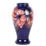 A William Moorcroft tube lined vase, 20th century of tall proportions, baluster shaped with sprays