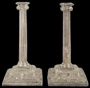 A pair of George III silver candlesticks, London 1764 of ionic part fluted columnar form, upon