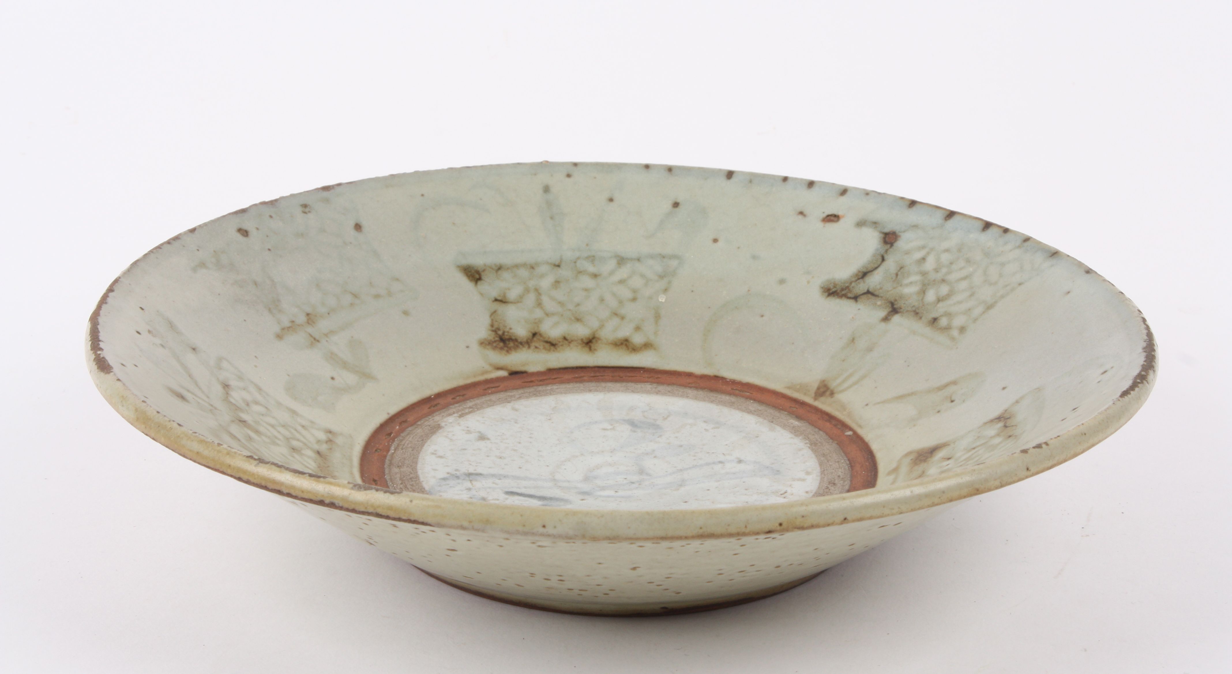 An 18th Century Chinese Swatow pale Celadon pottery dish the raised edge painted with planted