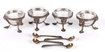 A set of four Victorian silver plated and glass salts dishes with four silver spoons, London 1824