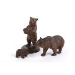 Three carved wooden black forest style bears, 20th century of small proportions, each carved with