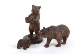 Three carved wooden black forest style bears, 20th century of small proportions, each carved with