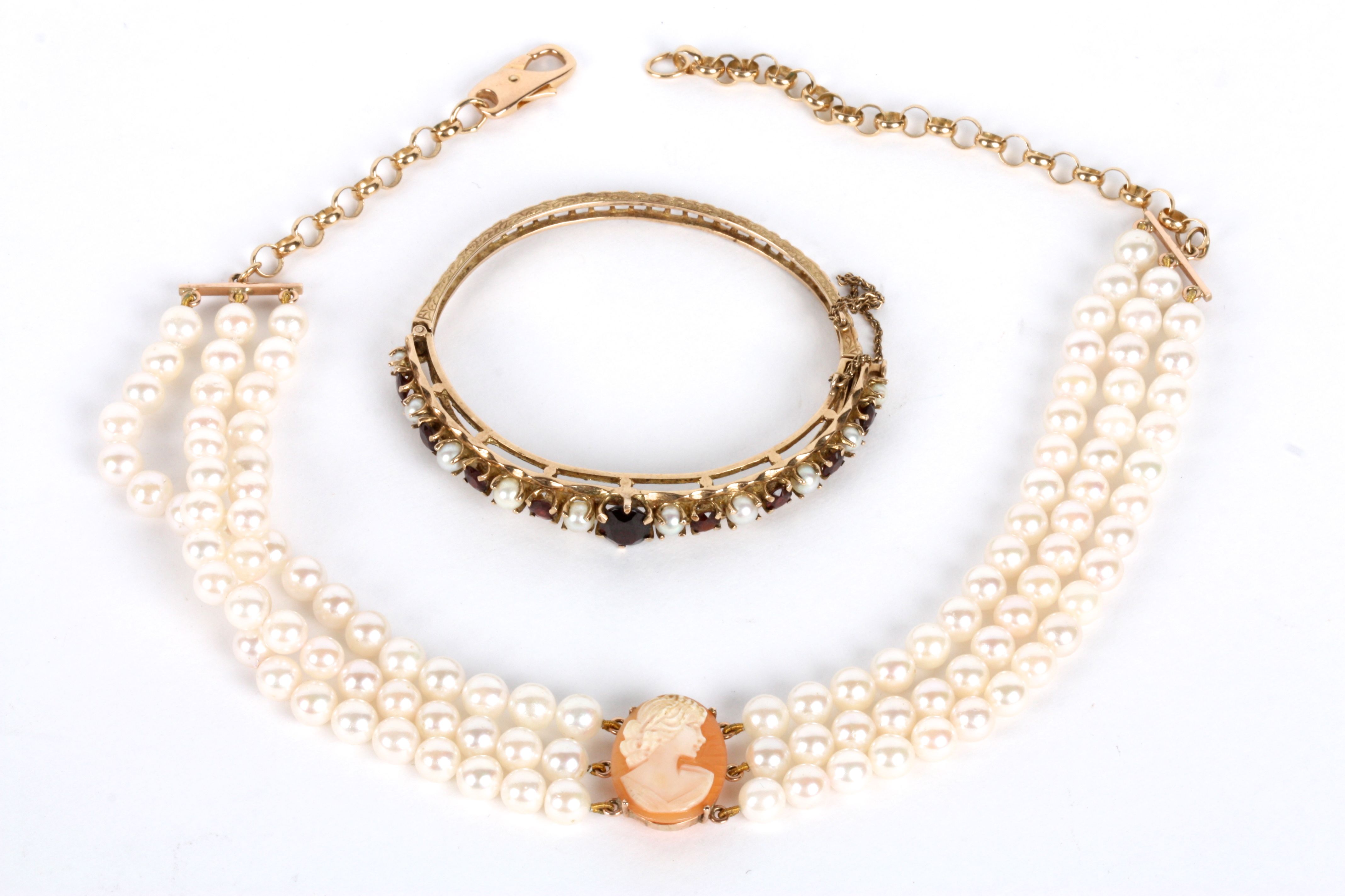 A contemporary three row pearl and gold mounted cameo choker The central carved portrait oval