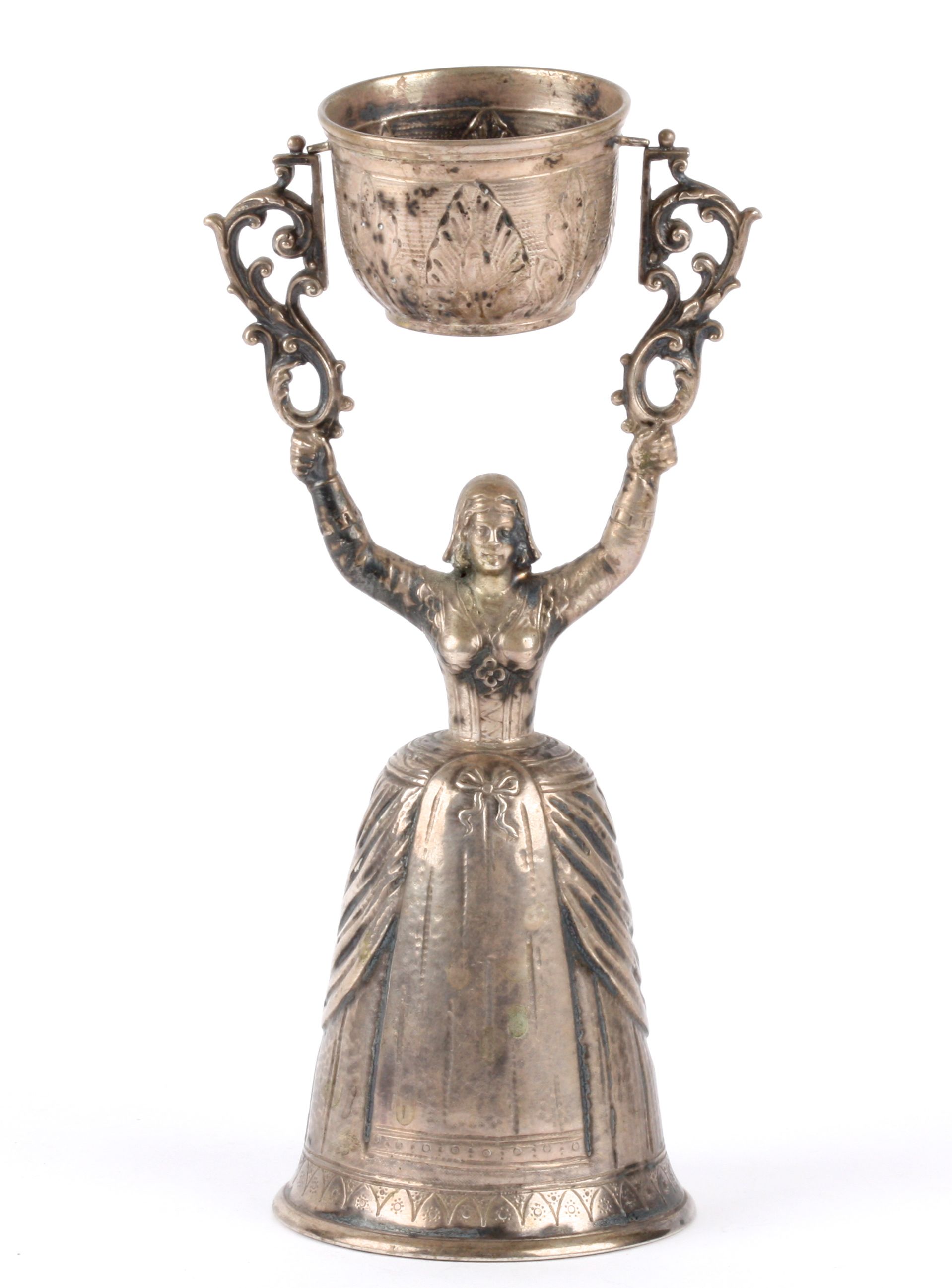 A Continental silver wager cup, 19th century modelled as a maiden standing with her arms above her