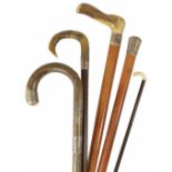 A malacca cane with silver handle walking stick together with two horn handled and silver banded