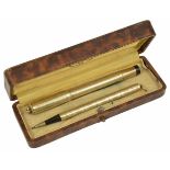 An early 20th century Star 18kr gold cased fountain pen and retracting pencil, each with engine