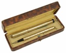 An early 20th century Star 18kr gold cased fountain pen and retracting pencil, each with engine