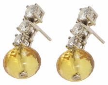 A pair of diamond and citrine drop earrings with three downwardly graduating diamonds with