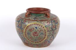 A large Eastern polychrome painted stoneware water pot the ovoid body painted overall with pink