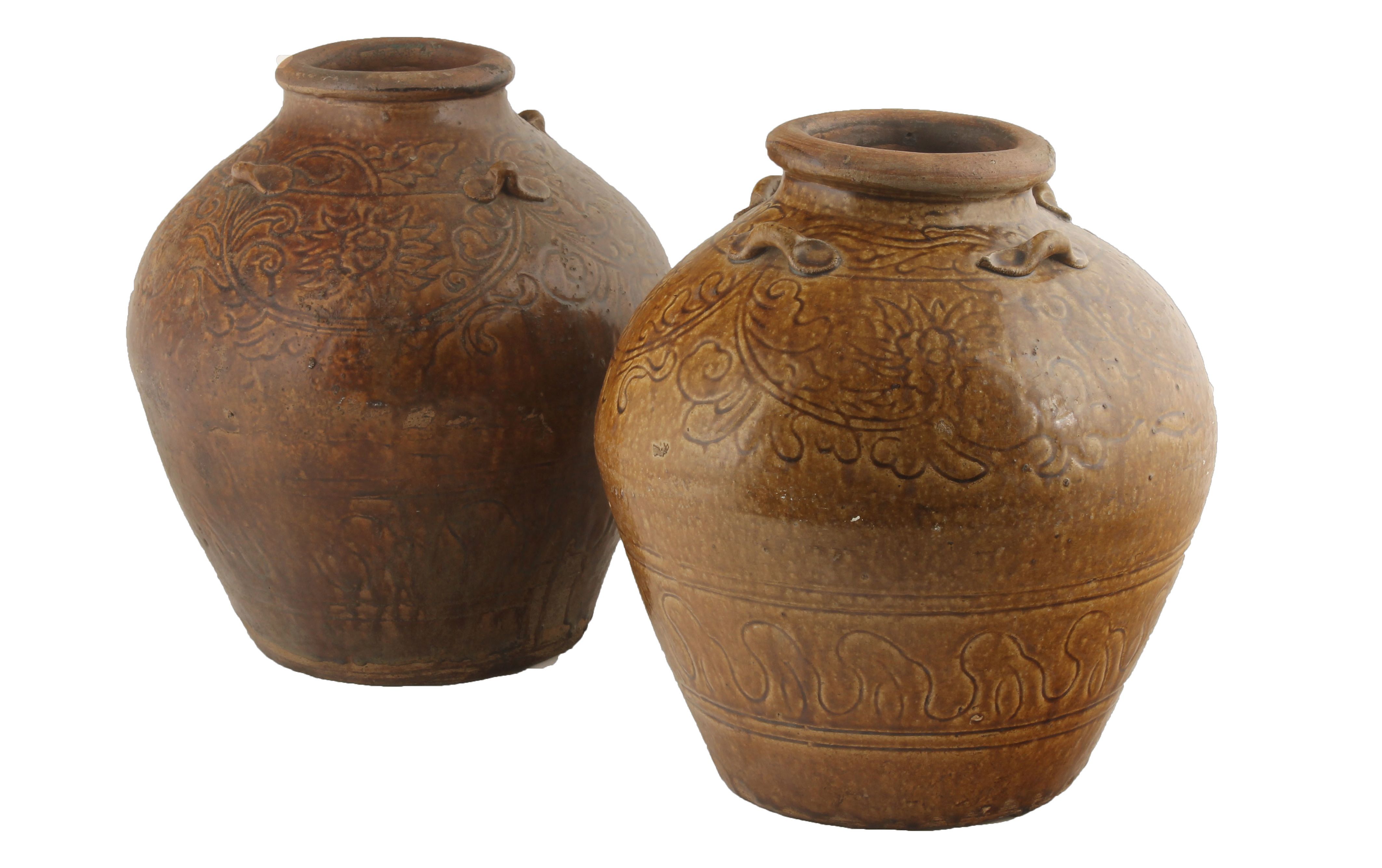 Two large Chinese late Ming Swatow stoneware, yellow glazed wine jars The ovoid shaped jars with