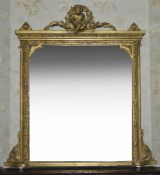 A Victorian gilt overmantel mirror, the seated putti with garlands of leaves surmounting a