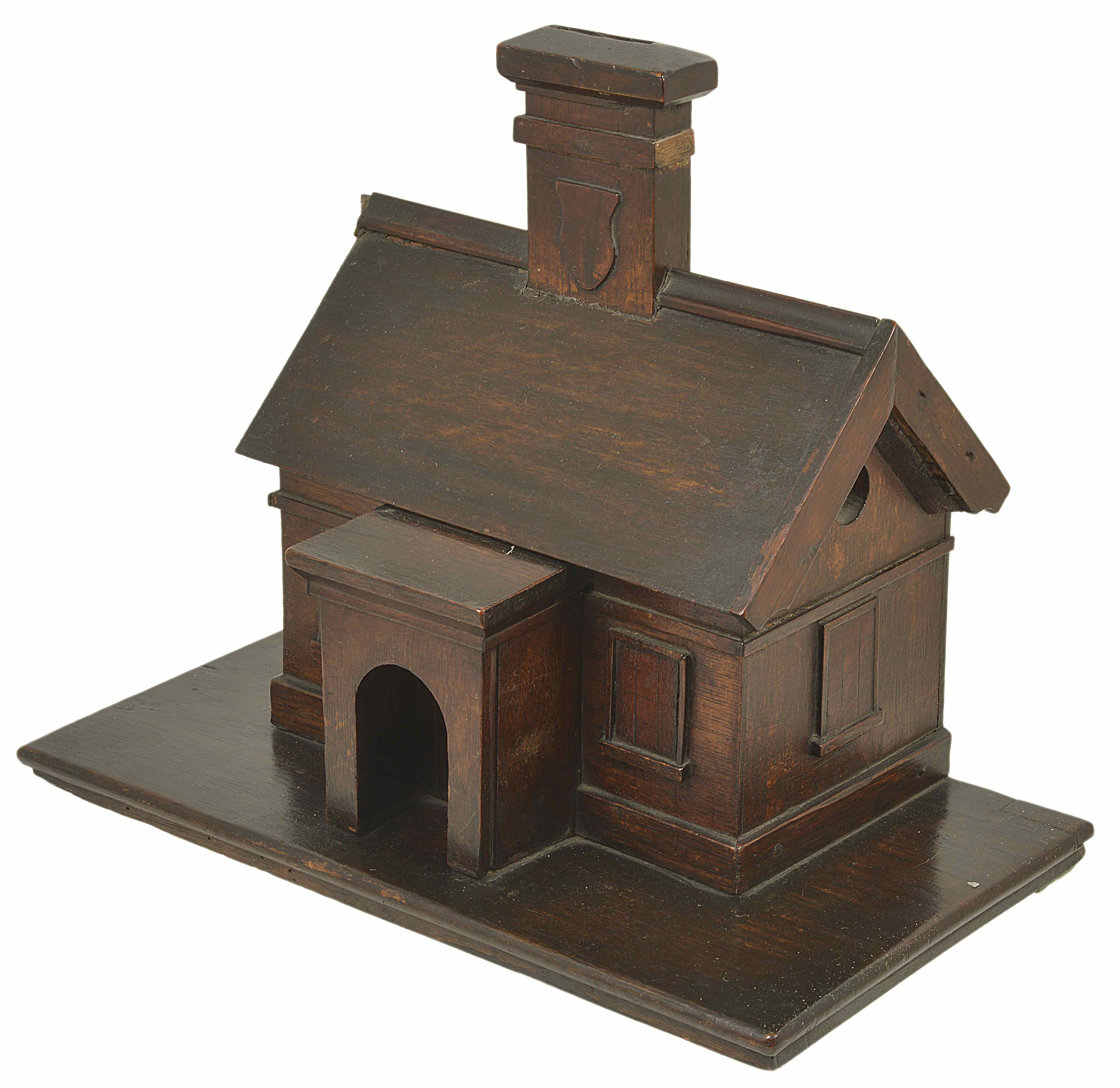 An oak novelty 'House money box', late 19th century modelled as a house with chimney, the chimney