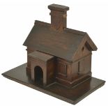 An oak novelty 'House money box', late 19th century modelled as a house with chimney, the chimney